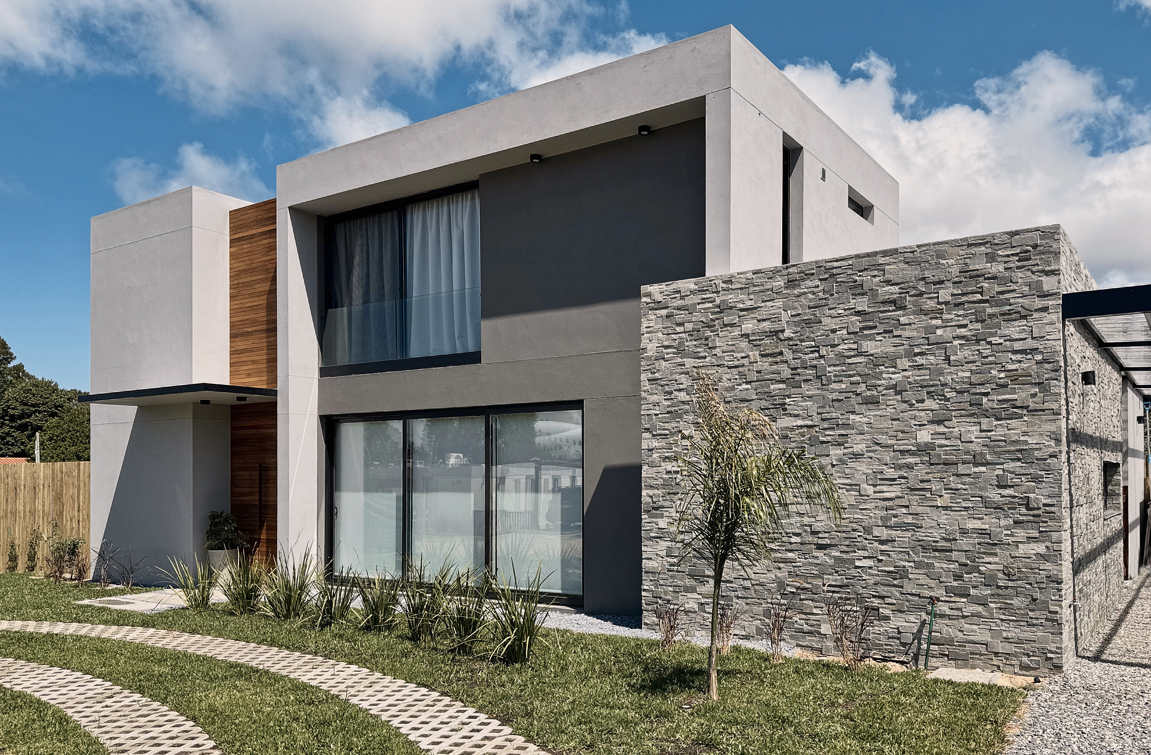 Vista exterior de Casa 8 Greenland con piedra, madera y jardín
